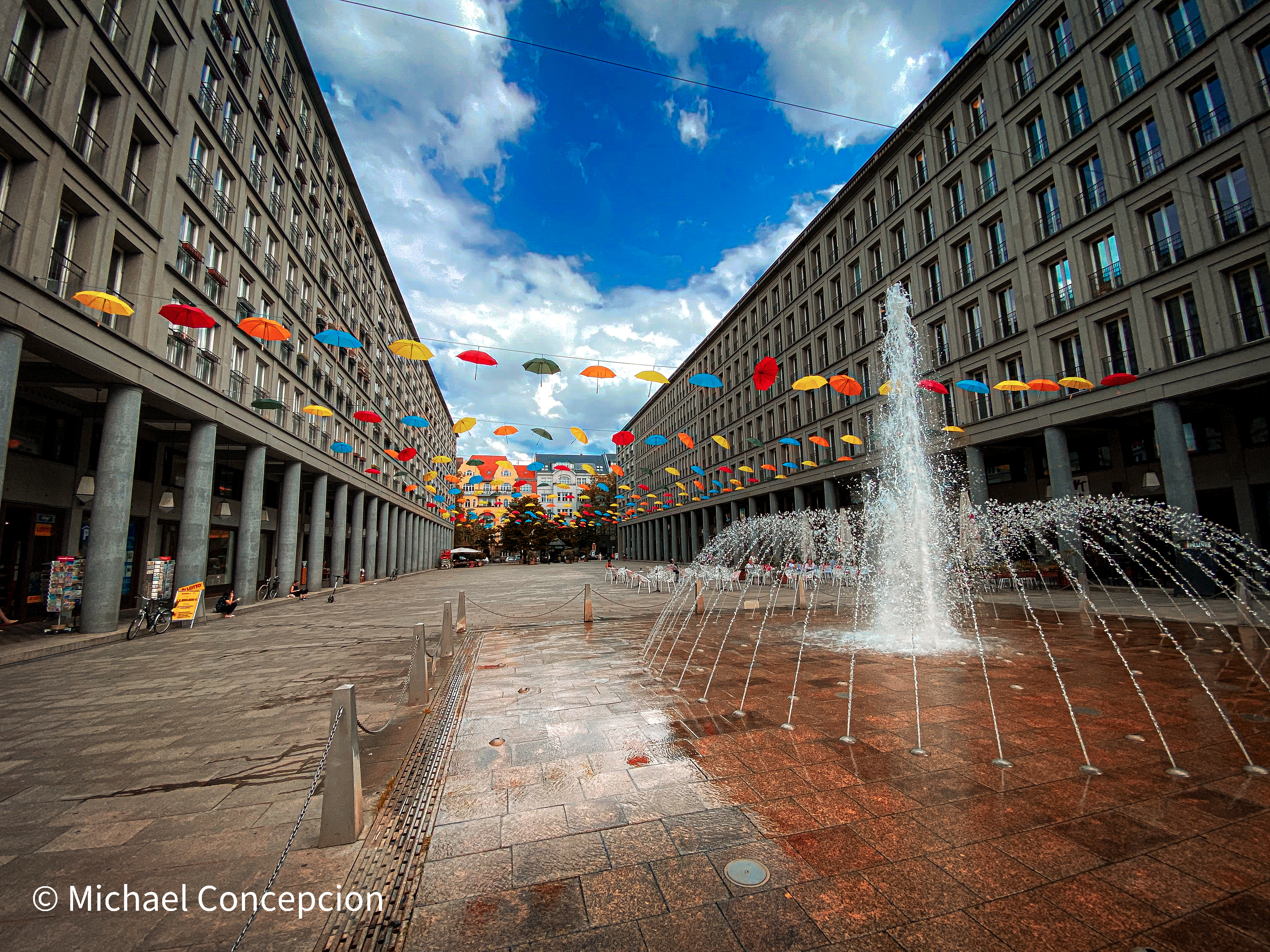 Colorful umbrellas suspended over a European plaza